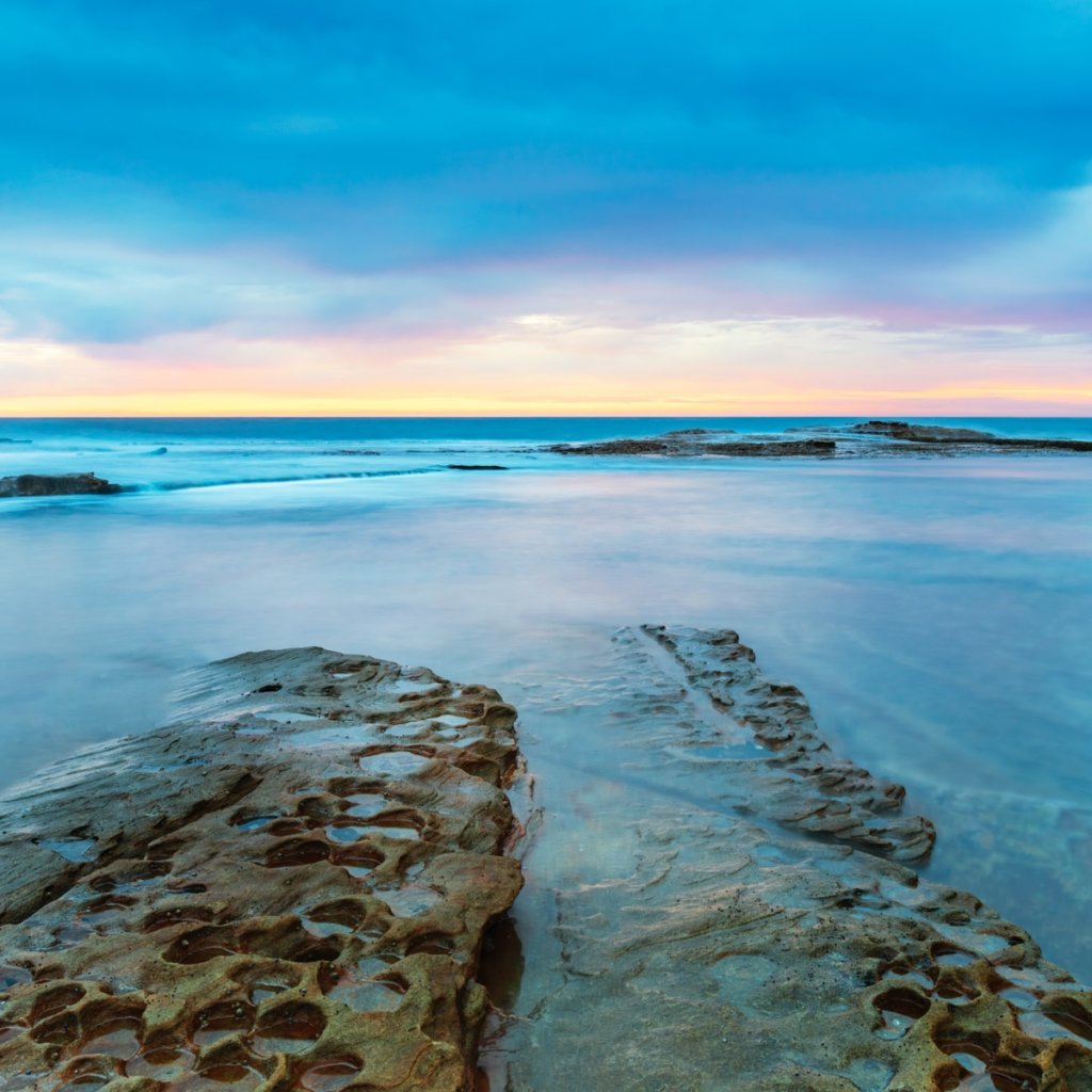 gray rocky shore during sunset